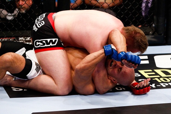 Barnett secures an arm triangle choke against Guelmino Barnett secures an arm triangle choke against Guelmino