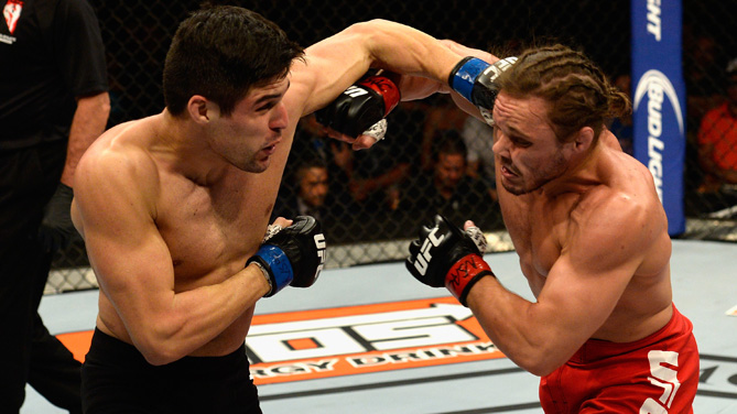 Vicente Luque punches Michael Graves in their welterweight bout during the Ultimate Fighter Finale inside MGM Grand Garden Arena on July 12, 2015 in Las Vegas, Nevada. (Photo by Brandon Magnus/Zuffa LLC)