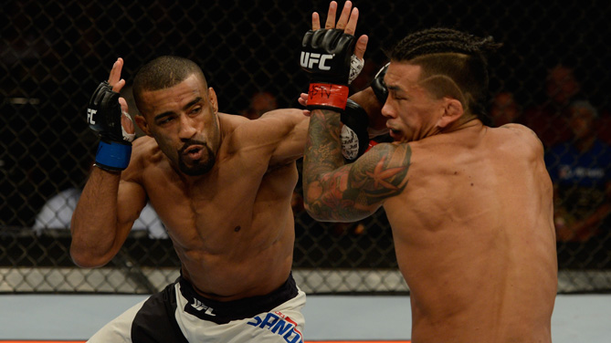 Jerrod Sanders punches Russell Doane in their bantamweight bout during the Ultimate Fighter Finale inside MGM Grand Garden Arena on July 12, 2015 in Las Vegas, Nevada. (Photo by Brandon Magnus/Zuffa LLC)