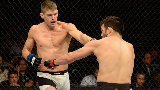 Stephen Thompson punches Jake Ellenberger in their welterweight bout during the Ultimate Fighter Finale inside MGM Grand Garden Arena on July 12, 2015 in Las Vegas, Nevada. (Photo by Brandon Magnus/Zuffa LLC)