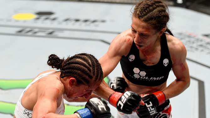 (R-L) Joanna Jedrzejczyk of Poland punches Jessica Penne of the United States in their women's strawweight championship bout during the UFC Fight Night event at the O2 World on June 20, 2015 in Berlin, Germany. (Photo by Josh Hedges/Zuffa LLC)