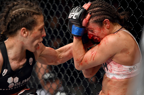 (L-R) Joanna Jedrzejczyk of Poland punches Jessica Penne of the United States in their women's strawweight championship bout during the UFC Fight Night event at the O2 World on June 20, 2015 in Berlin, Germany. (Photo by Josh Hedges/Zuffa LLC)