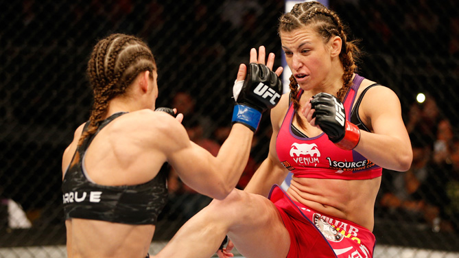 Miesha Tate kicks <a href='../fighter/Liz-Carmouche'>Liz Carmouche</a> in their women's bantamweight bout during the FOX UFC Saturday event at the Amway Center on April 19, 2014 in Orlando, Florida. (Photo by Josh Hedges/Zuffa LLC)