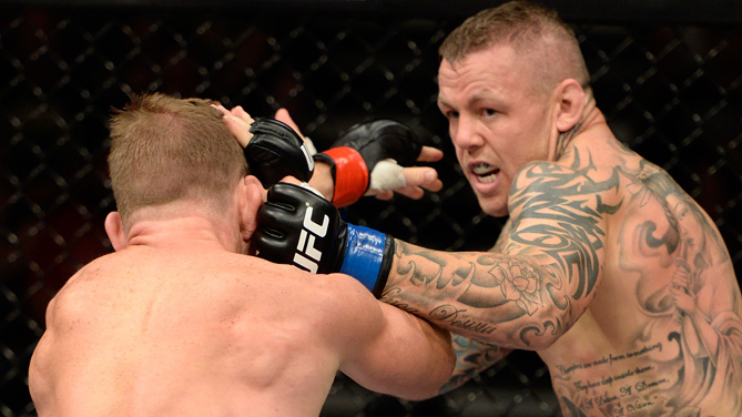Ross Pearson punches Gray Maynard in their lightweight bout during the UFC fight night event at the Cross Insurance Center on August 16, 2014 in Bangor, Maine. (Photo by Jeff Bottari/Zuffa LLC)