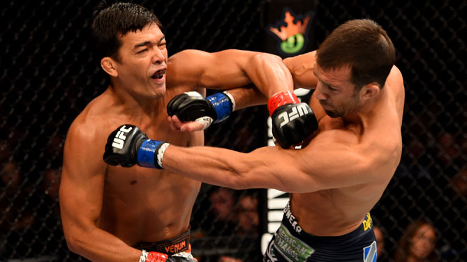 Luke Rockhold and Lyoto Machida of Brazil exchange blows in their middleweight bout during the UFC Fight Night event at Prudential Center on April 18, 2015 in Newark, New Jersey. (Photo by Josh Hedges/Zuffa LLC)