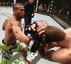 (L-R) Thiago Santos punches <a href='../fighter/Andy-Enz'>Andy Enz</a> in their middleweight bout during the UFC 183 event at the MGM Grand Garden Arena on January 31, 2015 in Las Vegas, Nevada. (Photo by Josh Hedges/Zuffa LLC)