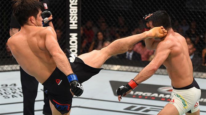 (L-R) Henry Cejudo of the United States kicks Jussier Formiga of Brazil in their flyweight bout during the UFC Fight Night event at Arena Monterrey on November 21, 2015 in Monterrey, Mexico. (Photo by Jeff Bottari/Zuffa LLC)
