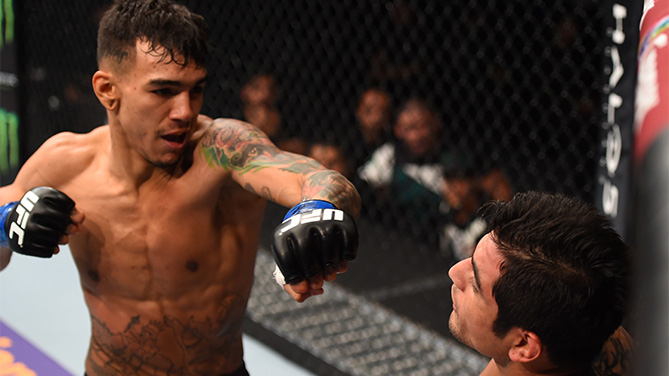 (L-R) <a href='../fighter/Andre-Fili'>Andre Fili</a> of the United States punches <a href='../fighter/gabriel-benitez'>Gabriel Benitez</a> of Mexico in their featherweight bout during the UFC Fight Night event at Arena Monterrey on November 21, 2015 in Monterrey, Mexico. (Photo by Jeff Bottari/Zuffa LLC)