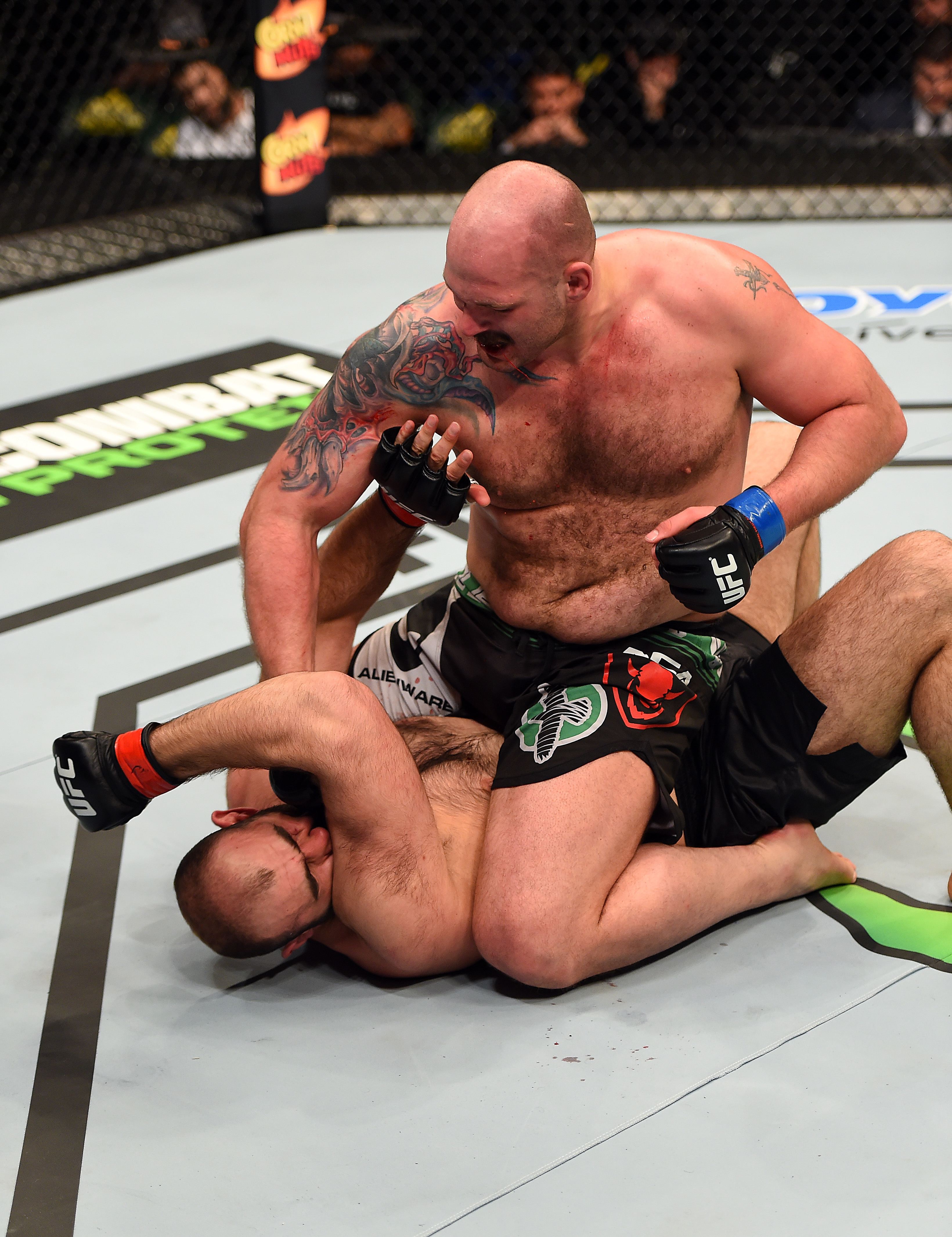 Timothy Johnson punches Shamil Abdurakhimov of Russia in their heavyweight fight during the UFC Fight Night event at the Patriot Center on April 4, 2015 in Fairfax, Virginia. (Photo by Josh Hedges/Zuffa LLC/Zuffa LLC via Getty Images)