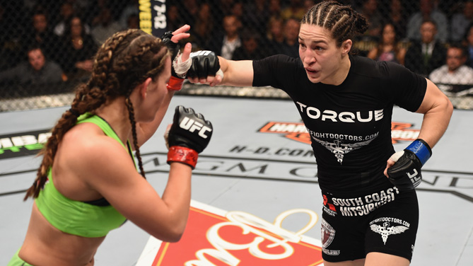 Sara McMann punches <a href='../fighter/Miesha-Tate'>Miesha Tate</a> in their women's bantamweight bout during the UFC 183 event at the MGM Grand Garden Arena on January 31, 2015 in Las Vegas, Nevada. (Photo by Josh Hedges/Zuffa LLC/Zuffa LLC via Getty Images)