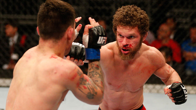 Dustin Ortiz punches Ray Borg in their flyweight bout during the FOX UFC Saturday event at the Amway Center on April 19, 2014 in Orlando, Florida. (Photo by Josh Hedges/Zuffa LLC/Zuffa LLC via Getty Images)
