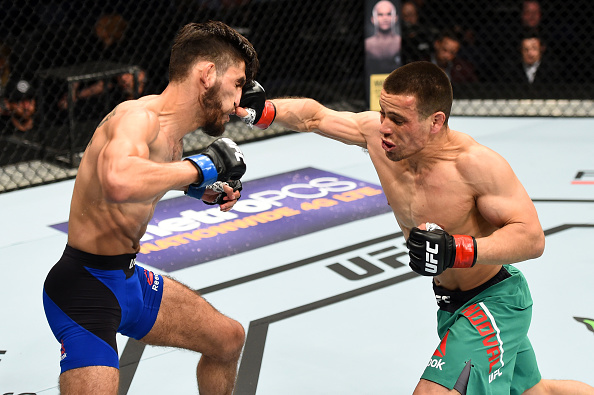 NASHVILLE, TN - APRIL 22: (R-L) Hector Sandoval punches Matt Schnell in their flyweight bout during the UFC Fight Night event at Bridgestone Arena on April 22, 2017 in Nashville, Tennessee. (Photo by Jeff Bottari/Zuffa LLC)