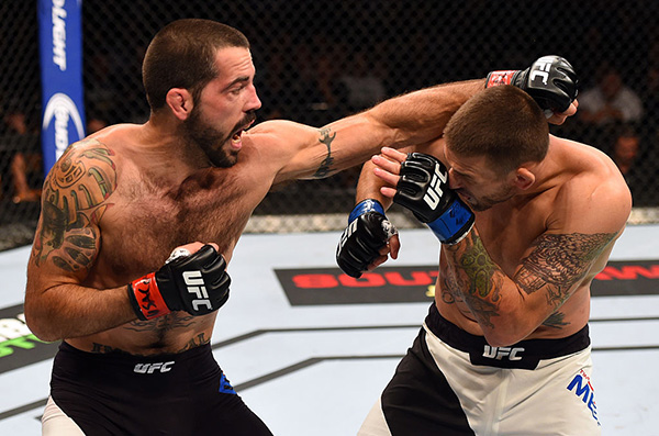 Matt Brown punches <a href='../fighter/Tim-Means'>Tim Means</a> in their welterweight fight during the UFC 189 event inside MGM Grand Garden Arena on July 11, 2015 in Las Vegas, Nevada. (Photo by Josh Hedges/Zuffa LLC)