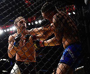 Joe Lauzon punches <a href='../fighter/Diego-Sanchez'>Diego Sanchez</a> in their lightweight bout during the UFC 200 event on July 9, 2016 at T-Mobile Arena in Las Vegas, NV (Photo by Harry How/Zuffa LLC)