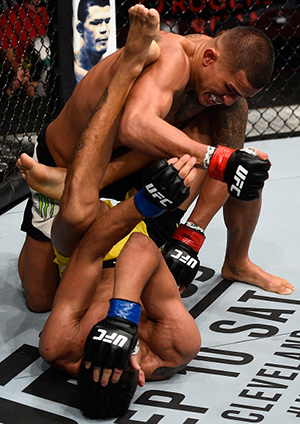 Anthony Pettis of the United States (top) punches <a href='../fighter/Charles-Oliveira'>Charles Oliveira</a> of Brazil in their featherweight bout during the <a href='../event/UFC-Silva-vs-Irvin'>UFC Fight Night </a>event at Rogers Arena on August 27, 2016 in Vancouver, British Columbia, Canada. (Photo by Jeff Bottari/Zuffa LLC)