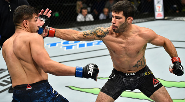 <a href='../fighter/Raphael-Assuncao'>Raphael Assuncao</a> of Brazil punches <a href='../fighter/matthew-lopez'>Matthew Lopez</a> in their bantamweight bout during the UFC Fight Night event inside the Ted Constant Convention Center on November 11, 2017 in Norfolk, Virginia. (Photo by Brandon Magnus/Zuffa LLC)