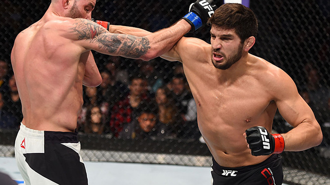 BOSTON, MA - JANUARY 17: (R-L) Patrick Cote of Canada punches Ben Saunders in their welterweight bout during the UFC Fight Night event inside TD Garden on January 17, 2016 in Boston, Massachusetts. (Photo by Jeff Bottari/Zuffa LLC)