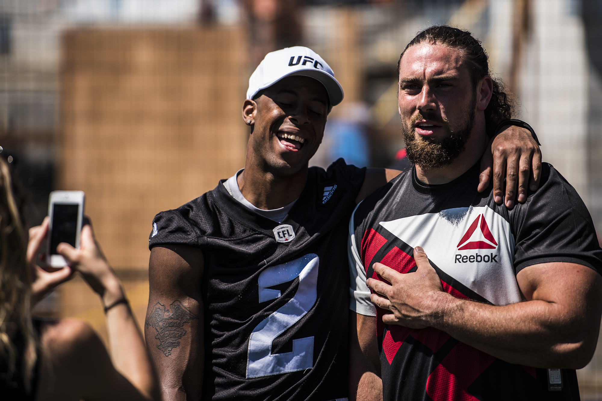 Jermaine Robinson (left) and Connor Williams (right) watch as UFC fighters Cowboy Cerrone and Misha Turkunov demonstrate proper MMA technique at Redblacks practice Wednesday afternoon. (John Barry/ Zuffa LLC)