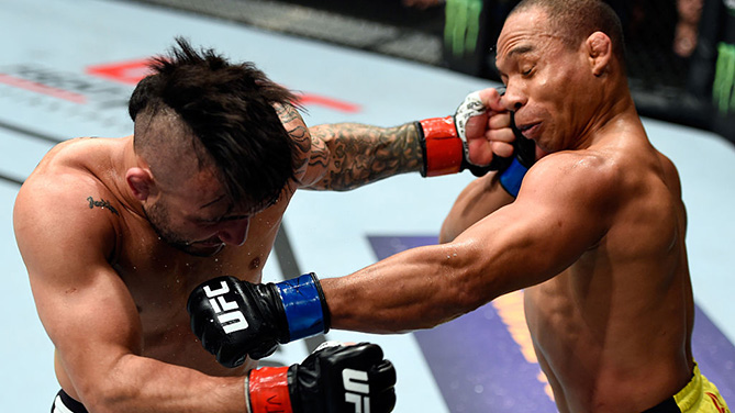 PORTLAND, OR - OCT. 1: (R-L) John Dodson and John Lineker of Brazil exchange punches in their bantamweight bout during the UFC Fight Night event at the Moda Center. (Photo by Josh Hedges/Zuffa LLC)