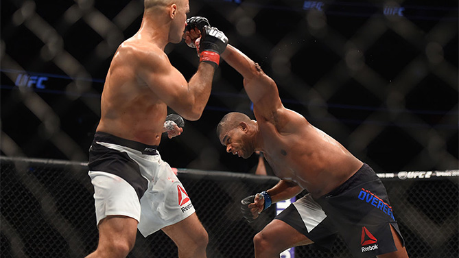ORLANDO, FL - DECEMBER 19: (R-L) Alistair Overeem punches Junior dos Santos in their heavyweight bout during the UFC Fight Night event at the Amway Center on December 19, 2015 in Orlando, Florida. (Photo by Jeff Bottari/Zuffa LLC)