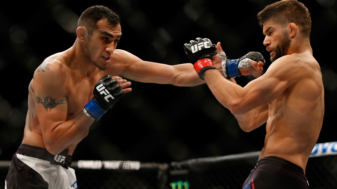 <a href='../fighter/Tony-Ferguson'>Tony Ferguson</a> punches <a href='../fighter/Josh-Thomson'>Josh Thomson</a> in their lightweight bout during the UFC event at the Valley View Casino Center on July 15, 2015 in San Diego, California. (Photo by Todd Warshaw/Zuffa LLC)