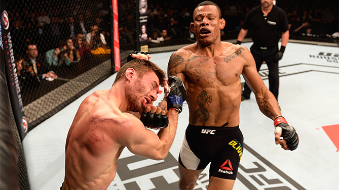 Alex Oliveira of Brazil punches Piotr Hallmann of Poland in their lightweight bout during the UFC Fight Night Belfort v Henderson at Ibirapuera Gymnasium on November 7, 2015 in Sao Paulo, Brazil. (Photo by Buda Mendes/Zuffa LLC)