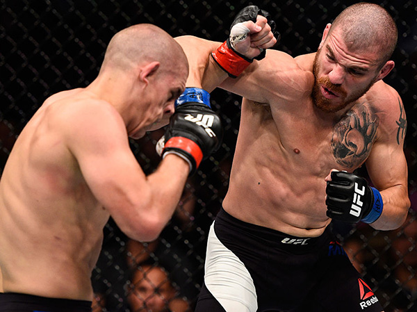 (R-L) <a href='../fighter/Jim-Miller'>Jim Miller</a> of the United States punches <a href='../fighter/Joe-Lauzon'>Joe Lauzon</a> of the United States in their lightweight bout during the <a href='../event/UFC-Silva-vs-Irvin'>UFC Fight Night </a>event at Rogers Arena on August 27, 2016 in Vancouver, British Columbia, Canada. (Photo by Jeff Bottari/Zuffa LLC)