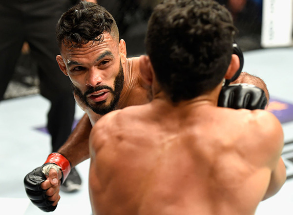 (L-R) <a href='../fighter/Rob-Font'>Rob Font</a> punches <a href='../fighter/Douglas-Silva-de-Andrade'>Douglas Silva de Andrade</a> of Brazil in their bantamweight bout during the UFC 213 event at T-Mobile Arena on July 8, 2017 in Las Vegas, Nevada. (Photo by Josh Hedges/Zuffa LLC)