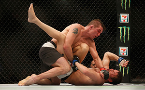 Darren Elkins (top) punches <a href='../fighter/Chas-Skelly'>Chas Skelly</a> during the UFC 196 on March 5, 2016 in Las Vegas, Nevada. (Photo by Christian Petersen/Zuffa LLC)