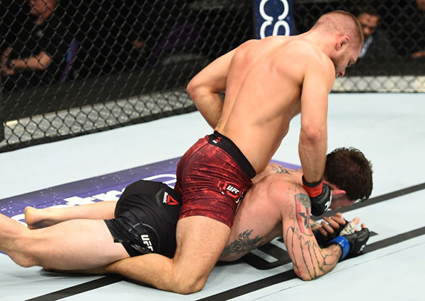 ST. LOUIS, MO - JANUARY 14: Mads Burnell of Denmark (top) punches Mike Santiago in their featherweight bout during the UFC Fight Night event inside the Scottrade Center on January 14, 2018 in St. Louis, Missouri. (Photo by Josh Hedges/Zuffa LLC/Zuffa LLC via Getty Images)