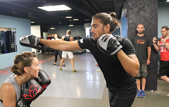 VANCOUVER, BC - AUG. 25 - (Right) Elias Theodorou throws a hook while holding mitts for Katie Cassidy (left) who ducks during a training session at In Fitness martial arts gym. (Photo by Matt Parrino/Zuffa LLC).