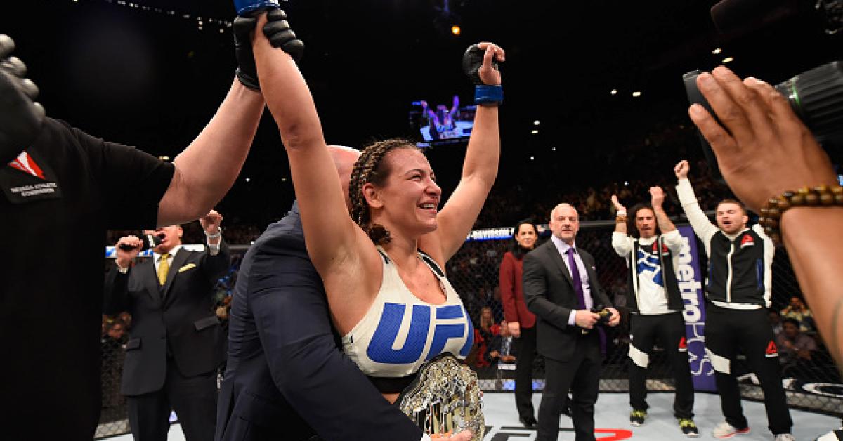 Tate wins title after late submission on Holm
