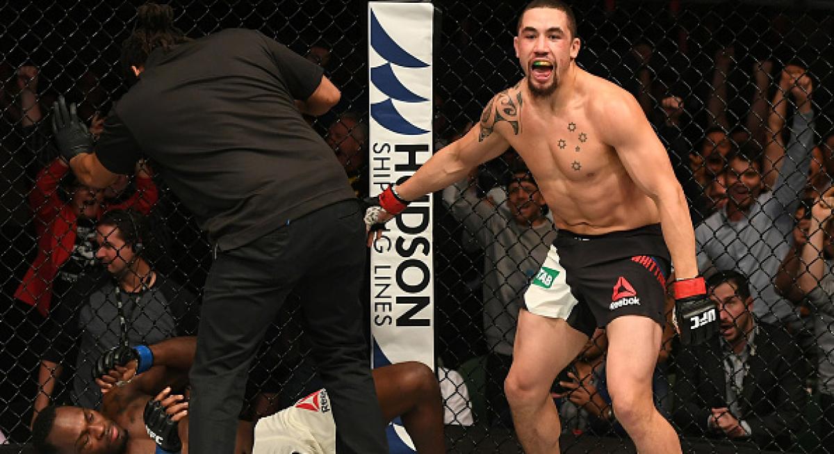 Whittaker ends epic first round with TKO
