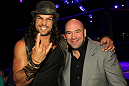 (L-R) Actor Jason Momoa and UFC President Dana White pose for a photo Octagonside at UFC 132.