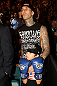 Musician Travis Barker and his son take in the fights at UFC 132.