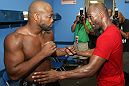 (R-L) World Champion boxer Bernard Hopkins gives Rashad Evans some boxing tips in the locker room at the Joe Hand Gym