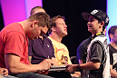Matt Mitrione signs an autograph for a young fan during a Q&A session at the UFC Fan Expo
