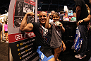 UFC fighter Pat Barry poses for a photo with a young fan at the UFC Fan Expo