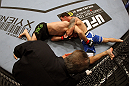 SAN JOSE, CA - NOVEMBER 19: Chris Weidman with a choke hold takes Tom Lawlor to the mat during an UFC Middleweight bout at the HP Pavillion on November 19, 2011 in San Jose, California.  (Photo by Josh Hedges/Zuffa LLC/Zuffa LLC via Getty Images)