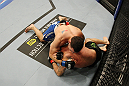 SAN JOSE, CA - NOVEMBER 19: Chris Weidman with a choke hold takes Tom Lawlor to the mat during an UFC Middleweight bout at the HP Pavillion on November 19, 2011 in San Jose, California.  (Photo by Josh Hedges/Zuffa LLC/Zuffa LLC via Getty Images)