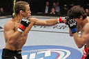 SAN JOSE, CA - NOVEMBER 19: (L-R) Urijah Faber punches Brian Bowles during an UFC Bantamweight bout at the HP Pavillion in San Jose, California on November 19, 2011 in San Jose, California.  (Photo by Josh Hedges/Zuffa LLC/Zuffa LLC via Getty Images)
