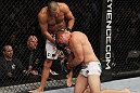 SAN JOSE, CA - NOVEMBER 19: (R-L) Mauricio Rua grabs hold of Dan Henderson's leg while taking a punch during an UFC Light Heavyweight bout at the HP Pavillion on November 19, 2011 in San Jose, California.  (Photo by Josh Hedges/Zuffa LLC/Zuffa LLC via Getty Images)
