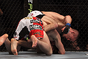 TORONTO, ON - DECEMBER 10:  (R-L) John Cholish punches Mitch Clarke during the UFC 140 event at Air Canada Centre on December 10, 2011 in Toronto, Ontario, Canada.  (Photo by Josh Hedges/Zuffa LLC/Zuffa LLC via Getty Images)