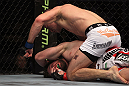 TORONTO, ON - DECEMBER 10:  (R-L) John Cholish punches Mitch Clarke during the UFC 140 event at Air Canada Centre on December 10, 2011 in Toronto, Ontario, Canada.  (Photo by Josh Hedges/Zuffa LLC/Zuffa LLC via Getty Images)