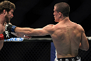TORONTO, ON - DECEMBER 10:  (R-L) John Cholish punches Mitch Clarke during the UFC 140 event at Air Canada Centre on December 10, 2011 in Toronto, Ontario, Canada.  (Photo by Josh Hedges/Zuffa LLC/Zuffa LLC via Getty Images)