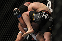LAS VEGAS, NV - DECEMBER 30:  Manny Gamburyan (black shorts) knees Diego Nunes during the UFC 141 event at the MGM Grand Garden Arena on December 30, 2011 in Las Vegas, Nevada.  (Photo by Josh Hedges/Zuffa LLC/Zuffa LLC via Getty Images) *** Local Caption *** Manny Gamburyan; Diego Nunes