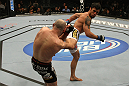 LAS VEGAS, NV - DECEMBER 30:  Diego Nunes (white shorts) kicks Manny Gamburyan (black shorts) during the UFC 141 event at the MGM Grand Garden Arena on December 30, 2011 in Las Vegas, Nevada.  (Photo by Donald Miralle/Zuffa LLC/Zuffa LLC via Getty Images) *** Local Caption *** Manny Gamburyan; Diego Nunes