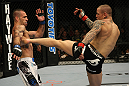 LAS VEGAS, NV - DECEMBER 30:  Ross Pearson (right) kicks Junior Assuncao (left) during the UFC 141 event at the MGM Grand Garden Arena on December 30, 2011 in Las Vegas, Nevada.  (Photo by Donald Miralle/Zuffa LLC/Zuffa LLC via Getty Images) *** Local Caption *** Ross Pearson; Junior Assuncao
