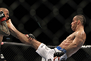 LAS VEGAS, NV - DECEMBER 30:  Junior Assuncao (right) kicks Ross Pearson (left) during the UFC 141 event at the MGM Grand Garden Arena on December 30, 2011 in Las Vegas, Nevada.  (Photo by Josh Hedges/Zuffa LLC/Zuffa LLC via Getty Images) *** Local Caption *** Junior Assuncao; Ross Pearson