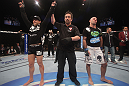 LAS VEGAS, NV - DECEMBER 30:  Ross Pearson (left) is declared the winner over his opponent Junior Assuncao (right) during the UFC 141 event at the MGM Grand Garden Arena on December 30, 2011 in Las Vegas, Nevada.  (Photo by Donald Miralle/Zuffa LLC/Zuffa LLC via Getty Images) *** Local Caption *** Ross Pearson; Junior Assuncao